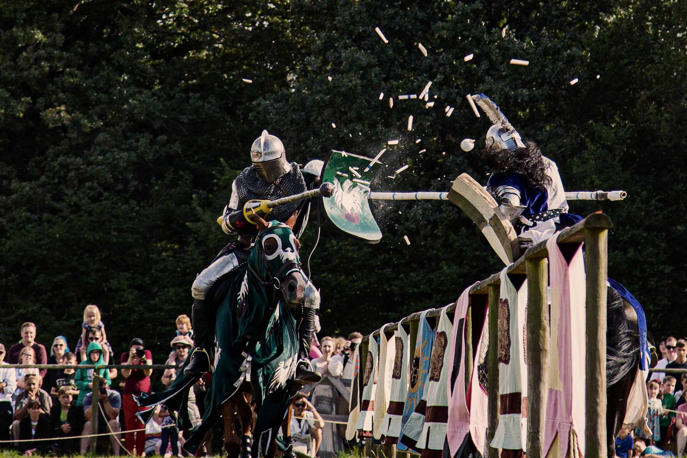 A jouster's lance explodes on contact with the shield of the opposing knight